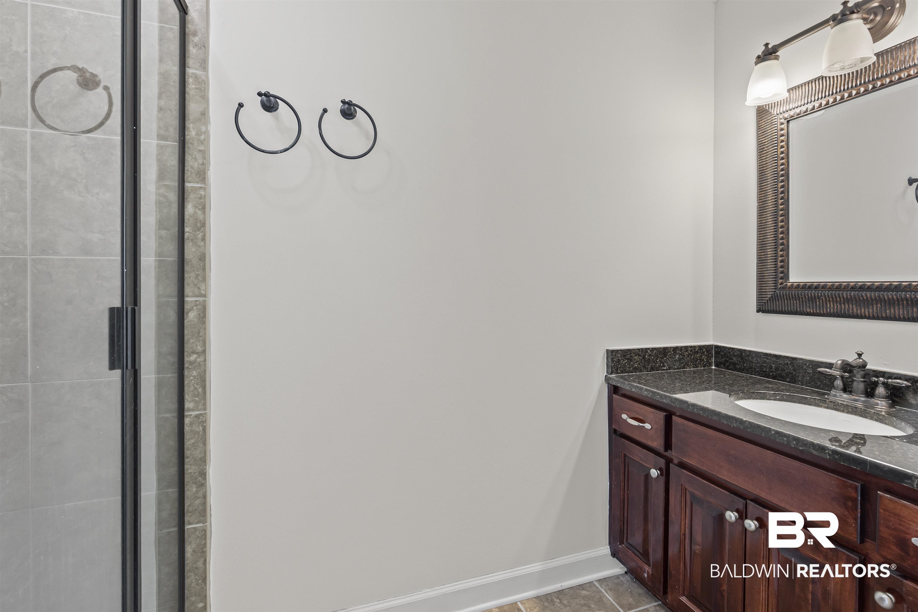 924 Brady Road North Bay Minette, AL 36507 - Photo 24 of 26 Bathroom featuring vanity, tiled shower, and tile patterned floors