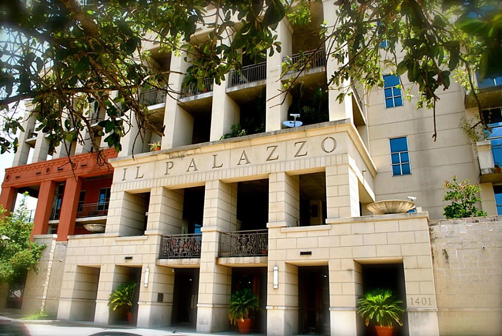 1401 Calumet Street, Unit 300 Houston, TX 77004 - Photo 1 of 31 This photo showcases a modern, upscale condominium building with a grand entrance, featuring large columns and elegant balconies. The exterior is adorned with lush greenery, offering a welcoming and stylish urban living environment.