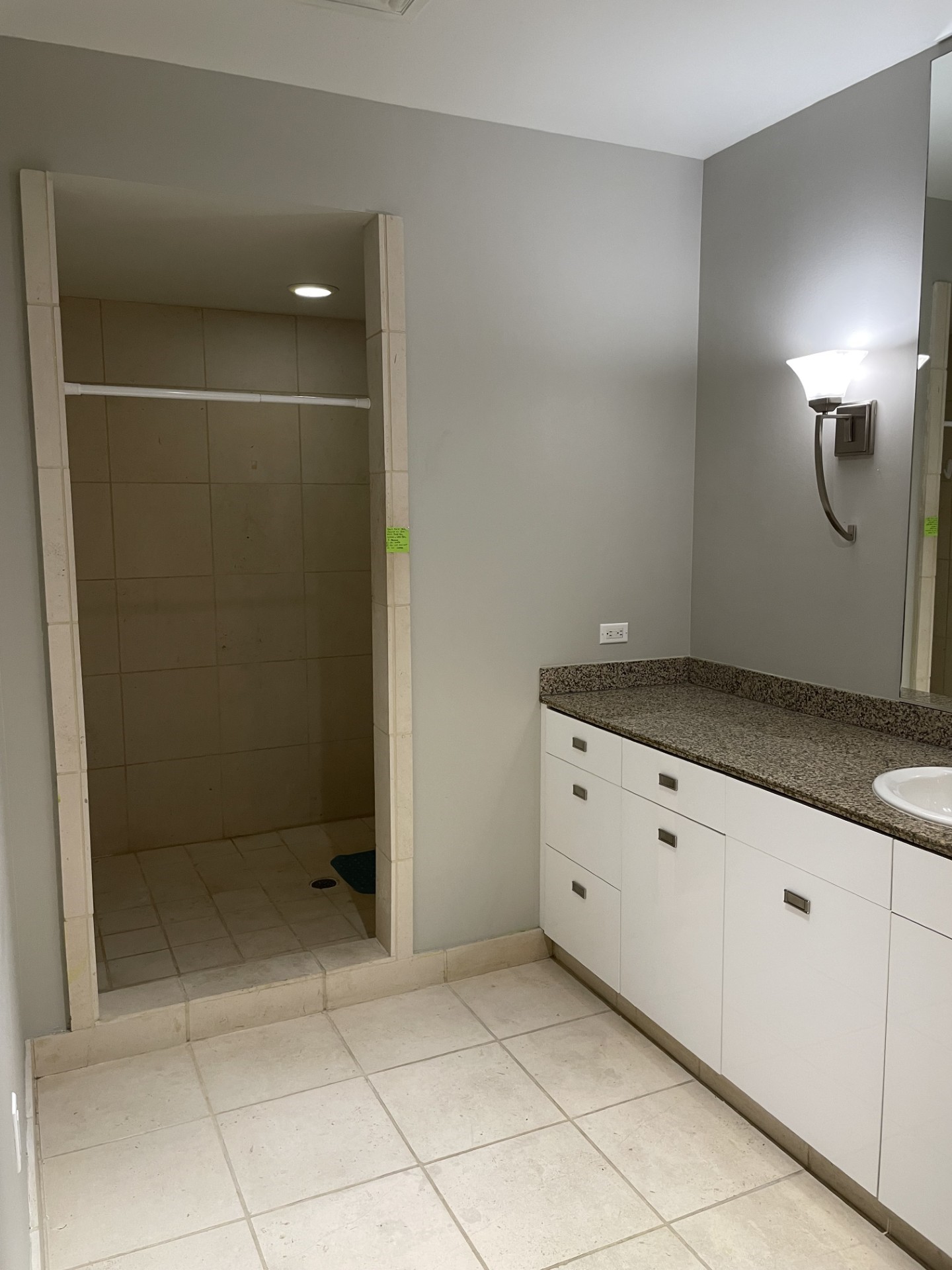 1401 Calumet Street, Unit 300 Houston, TX 77004 - Photo 19 of 31 This bathroom features a tiled walk-in shower, a modern vanity with granite countertop, and ample storage space. The neutral tones and sleek lighting create a clean, contemporary feel.