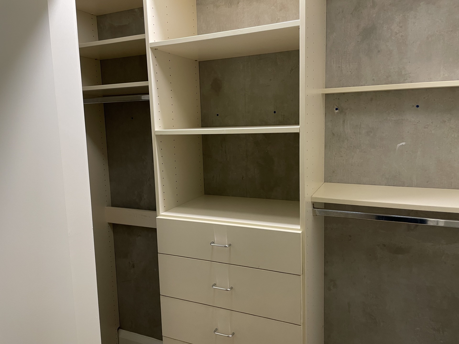 1401 Calumet Street, Unit 300 Houston, TX 77004 - Photo 27 of 31 This photo shows a spacious walk-in closet with ample shelving and drawer space, featuring a modern design and neutral tones, perfect for organized storage.