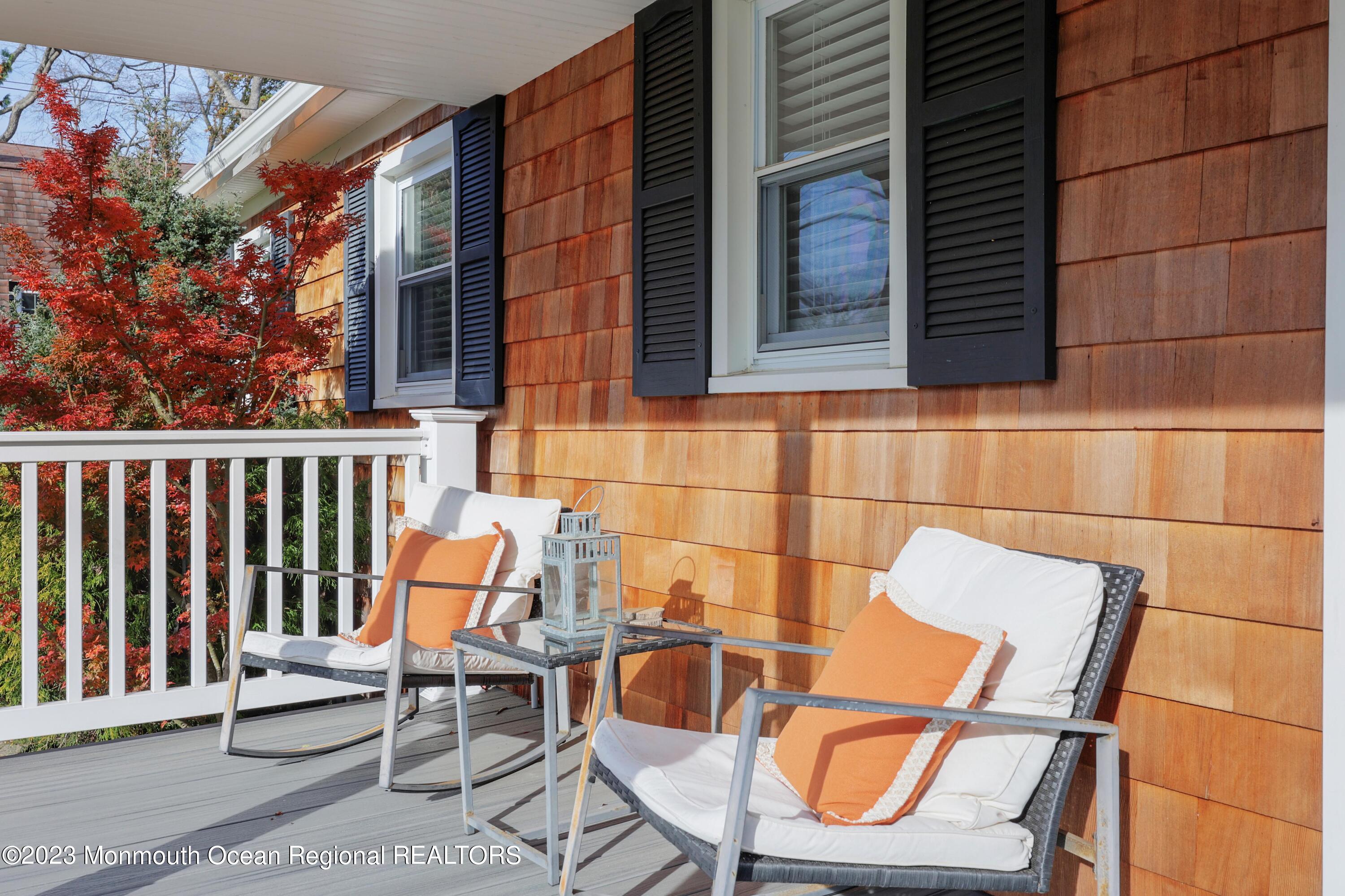 1208 Oak Road Manasquan, NJ 08736 - Photo 11 of 52 a view of a chairs and table in the back yard of the house