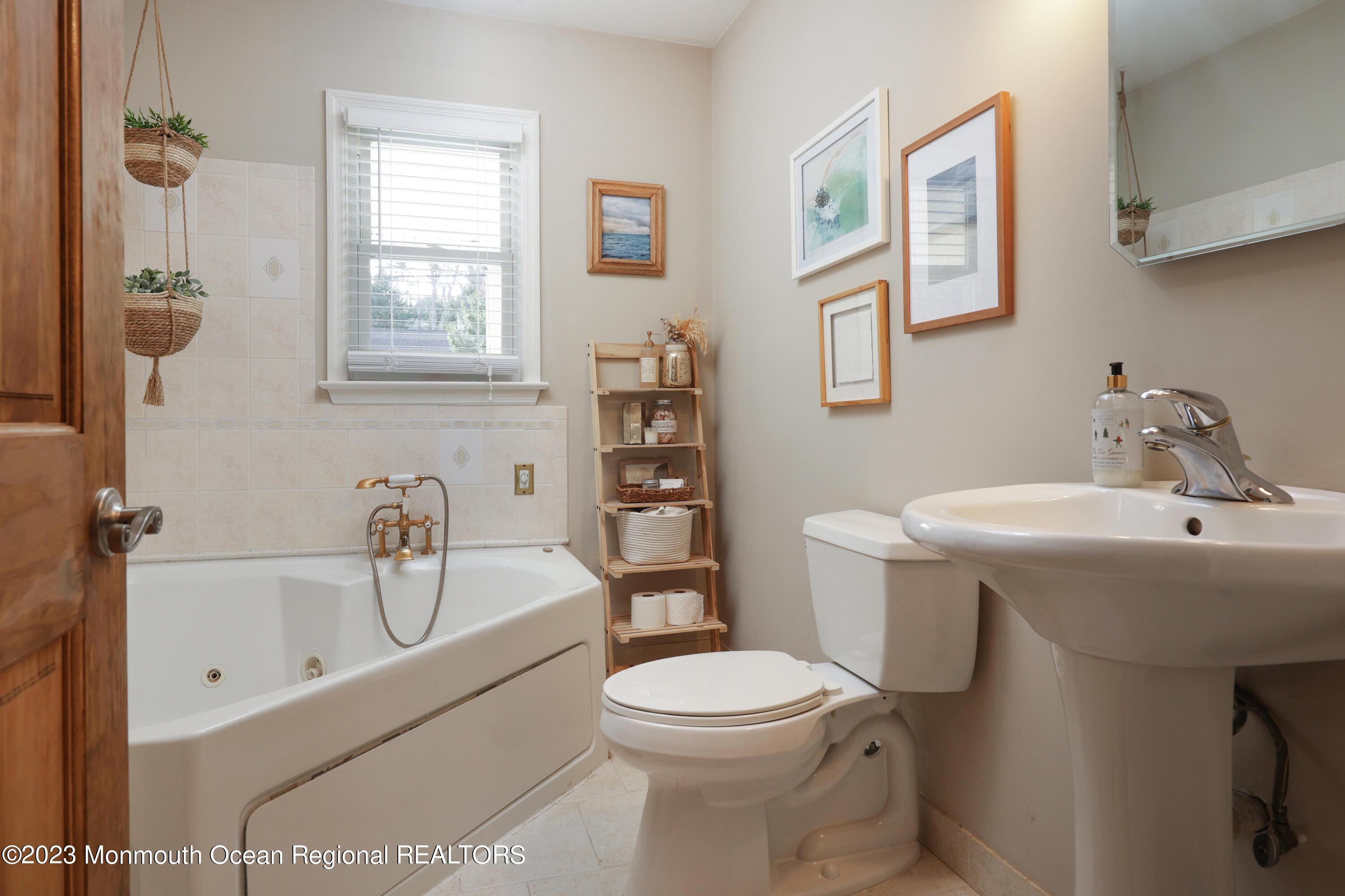 1208 Oak Road Manasquan, NJ 08736 - Photo 21 of 52 a bathroom with a toilet sink and mirror