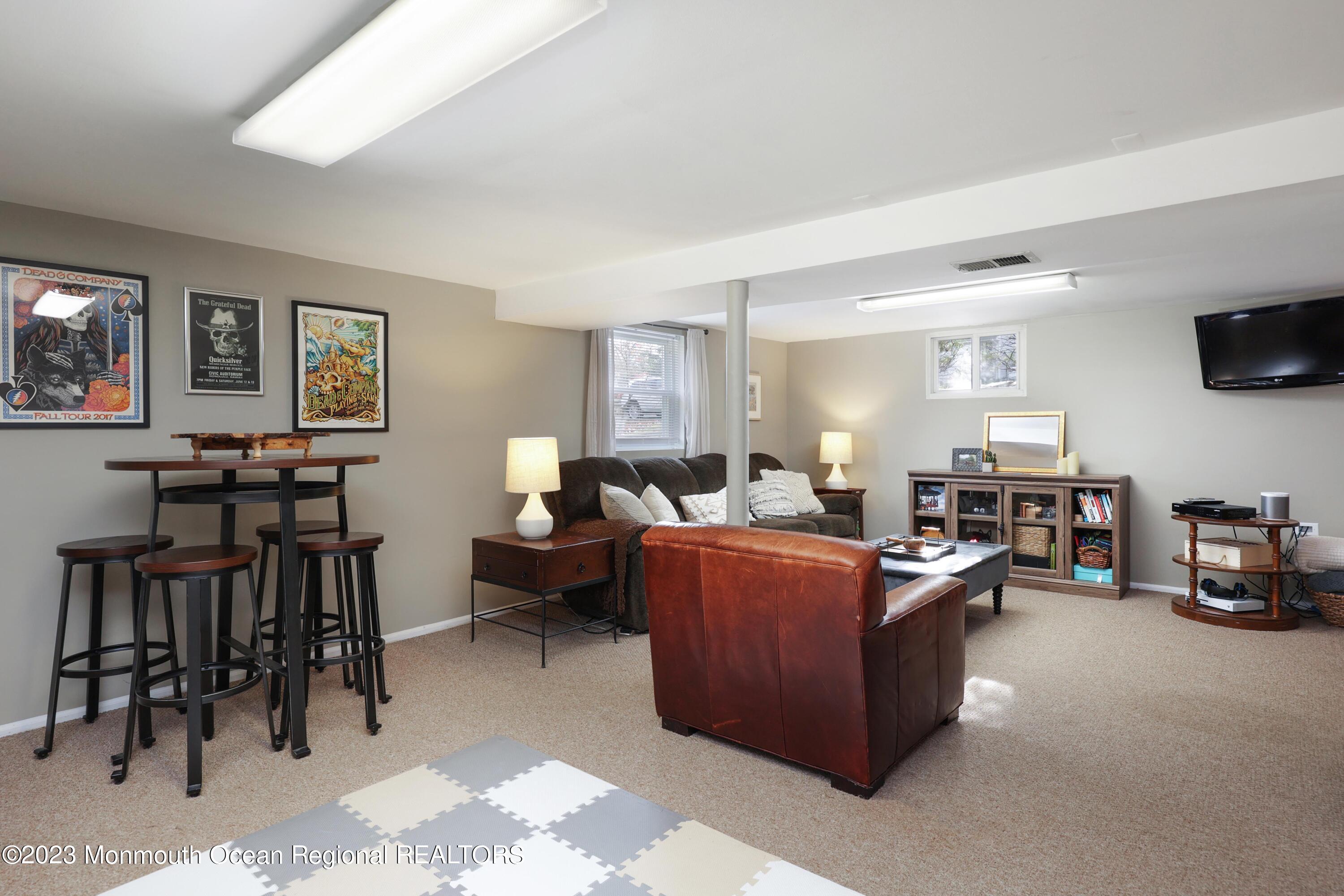 1208 Oak Road Manasquan, NJ 08736 - Photo 28 of 52 a living room with furniture and a flat screen tv