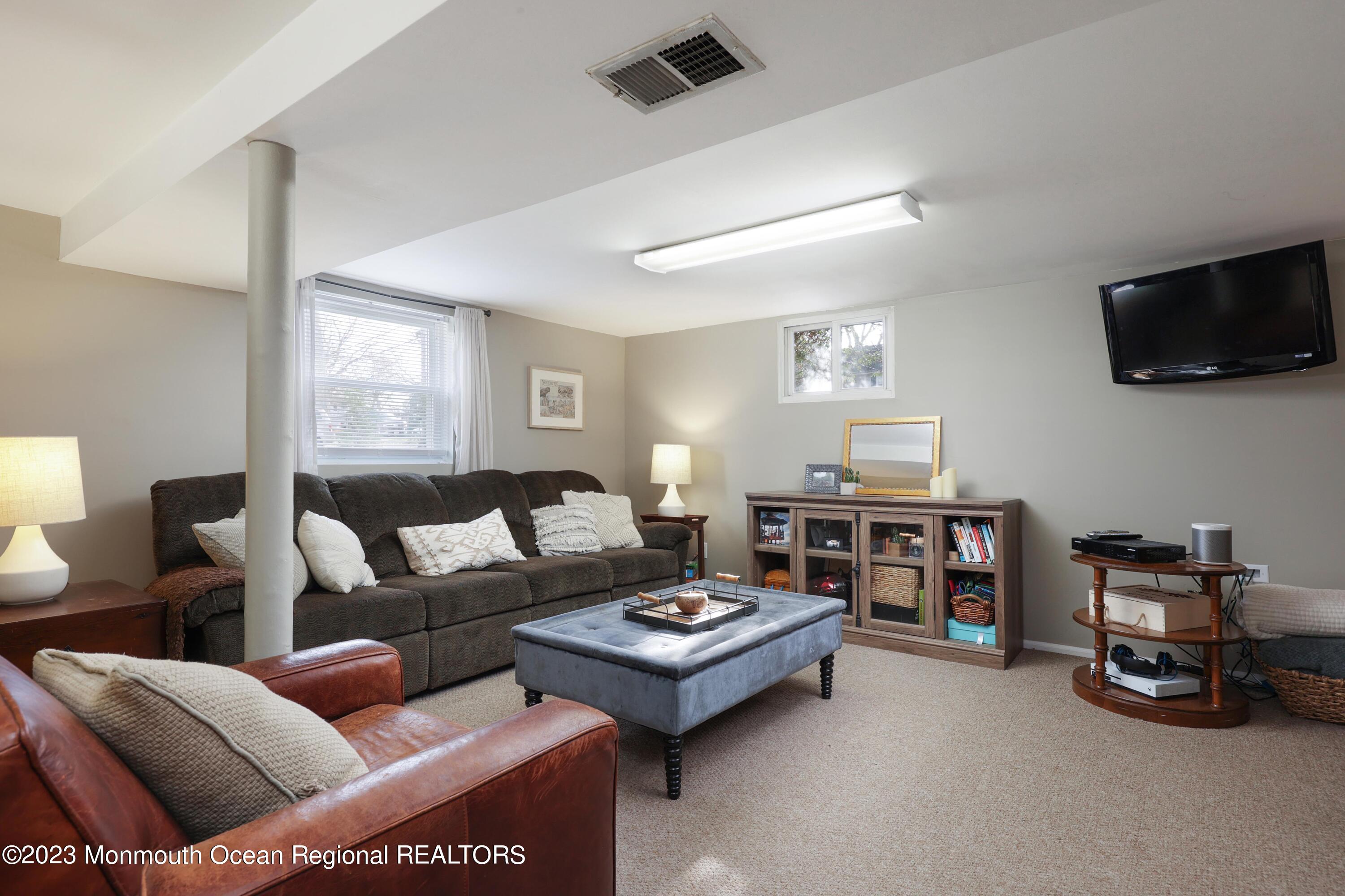 1208 Oak Road Manasquan, NJ 08736 - Photo 29 of 52 a living room with furniture and a flat screen tv