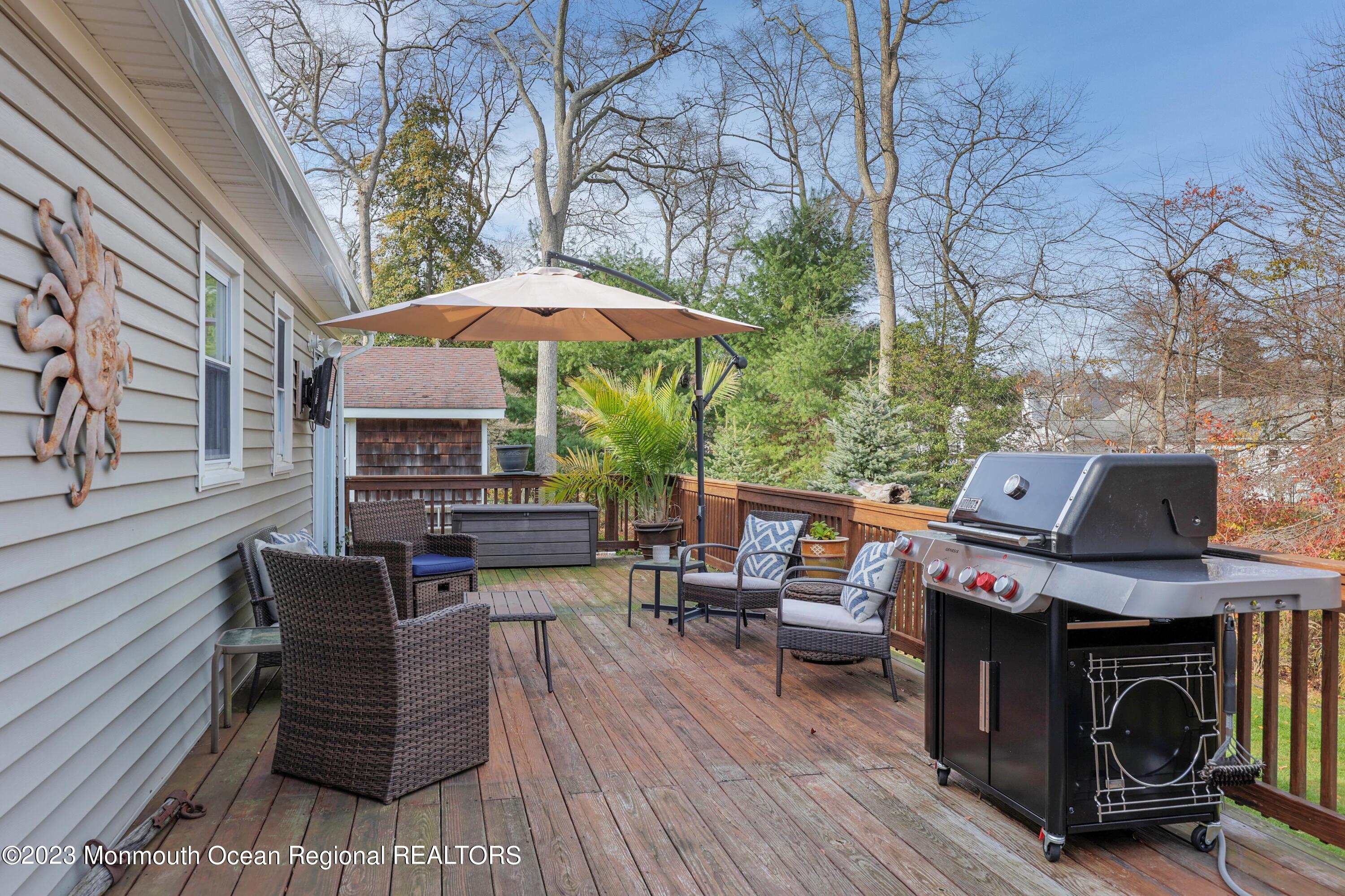 1208 Oak Road Manasquan, NJ 08736 - Photo 31 of 52 a patio with hardwood table and chairs