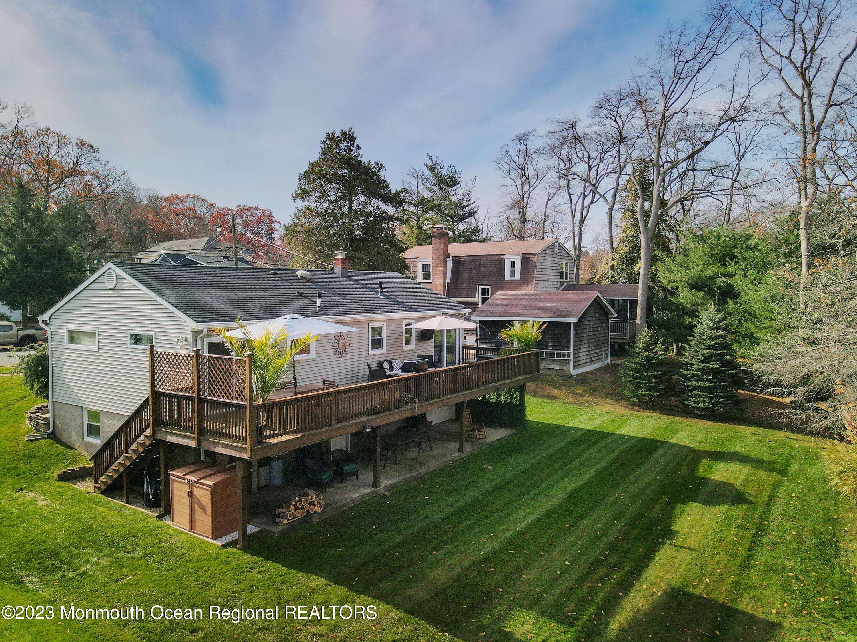 1208 Oak Road Manasquan, NJ 08736 - Photo 34 of 52 a aerial view of a house with a yard balcony and a slide