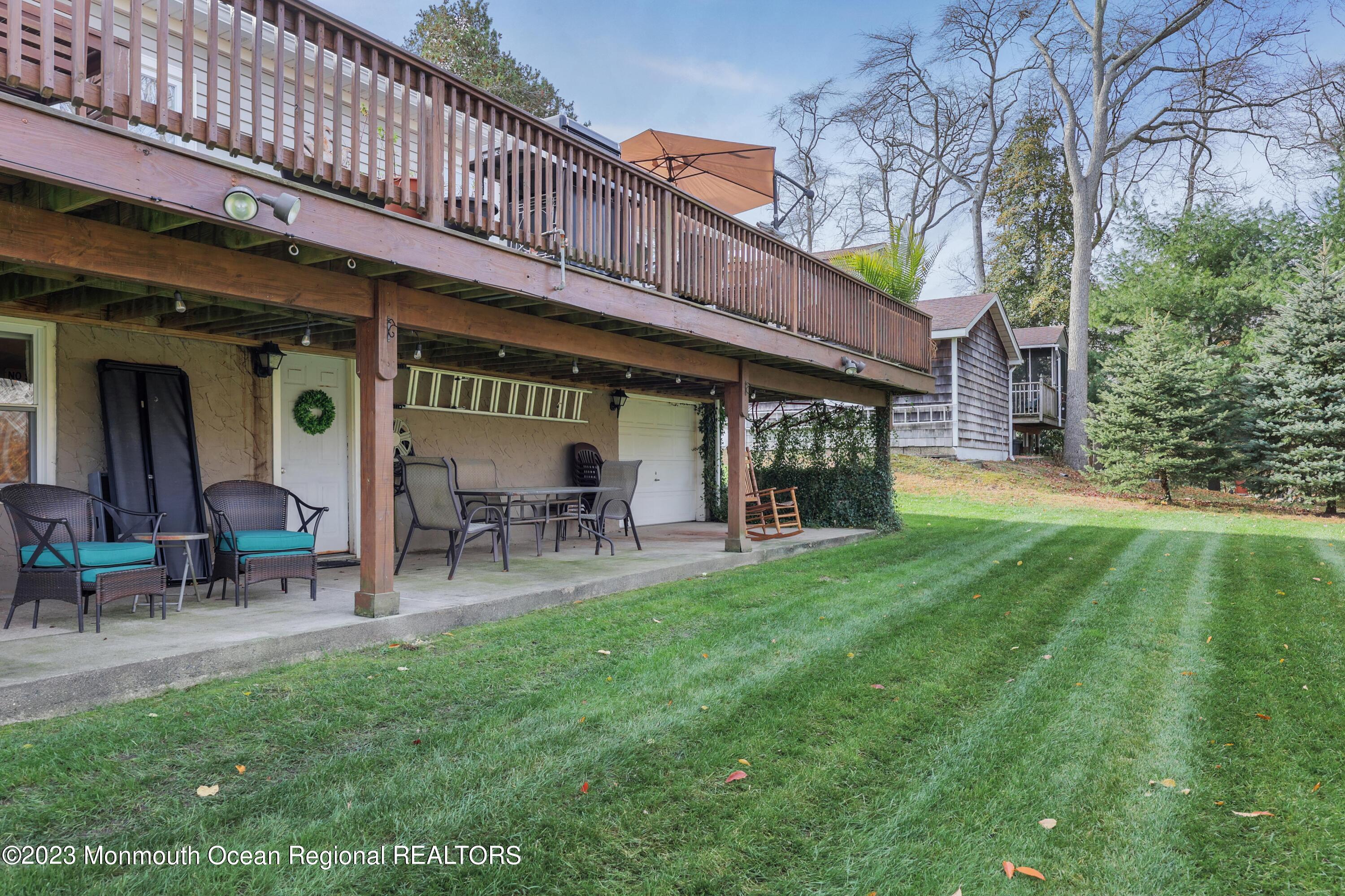 1208 Oak Road Manasquan, NJ 08736 - Photo 37 of 52 a view of a house with a backyard porch and sitting area