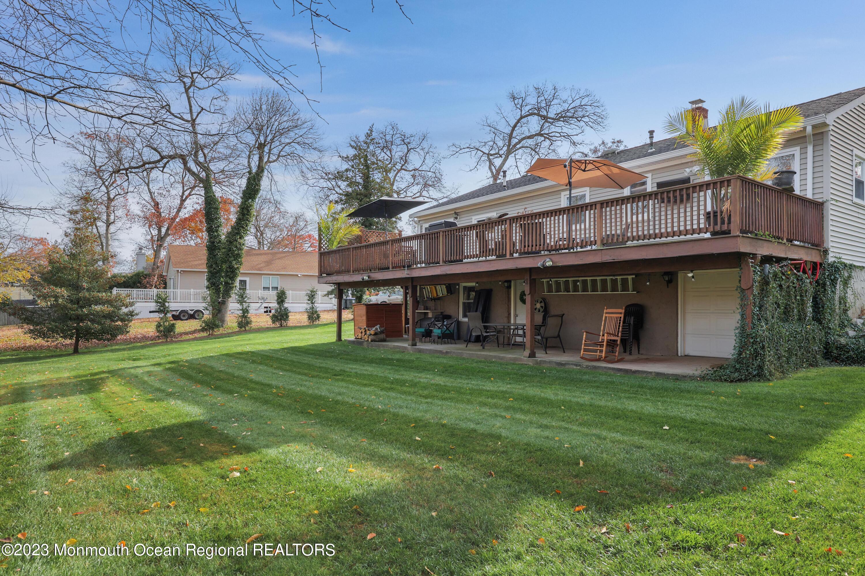 1208 Oak Road Manasquan, NJ 08736 - Photo 38 of 52 a view of a big house with a big yard and large trees