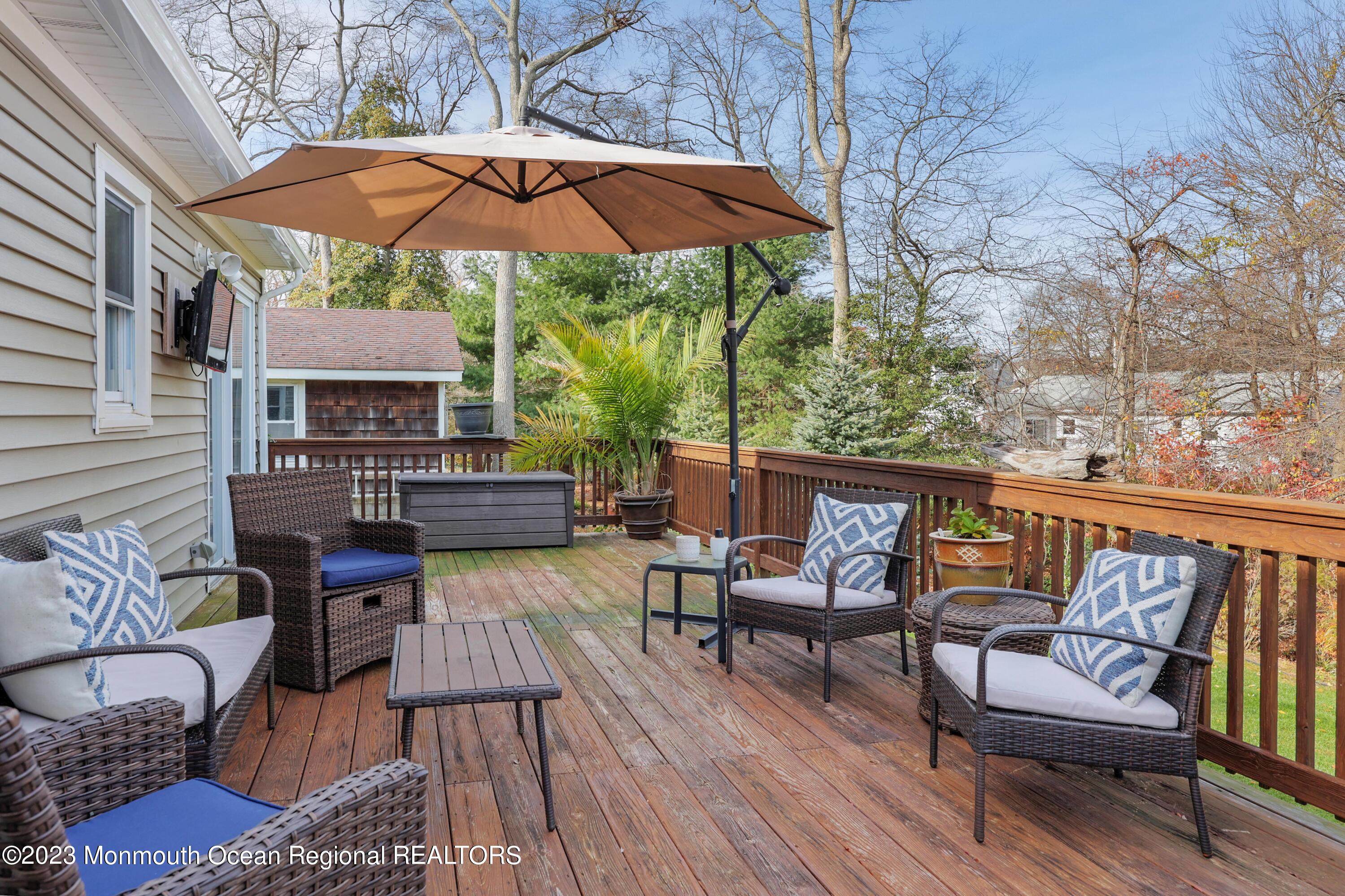 1208 Oak Road Manasquan, NJ 08736 - Photo 4 of 52 a view of a chairs and table in the patio
