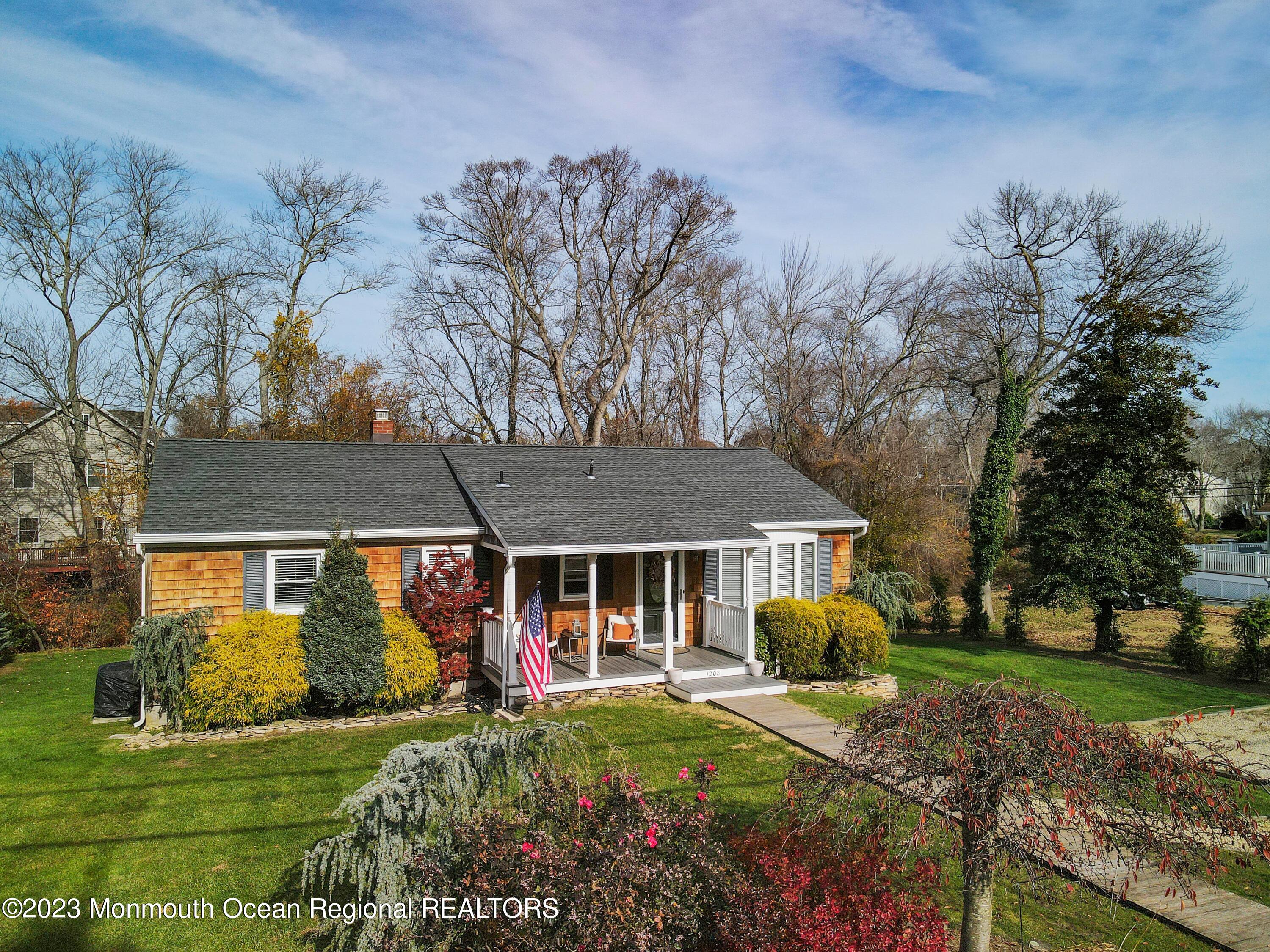 1208 Oak Road Manasquan, NJ 08736 - Photo 5 of 52 a front view of a house with garden