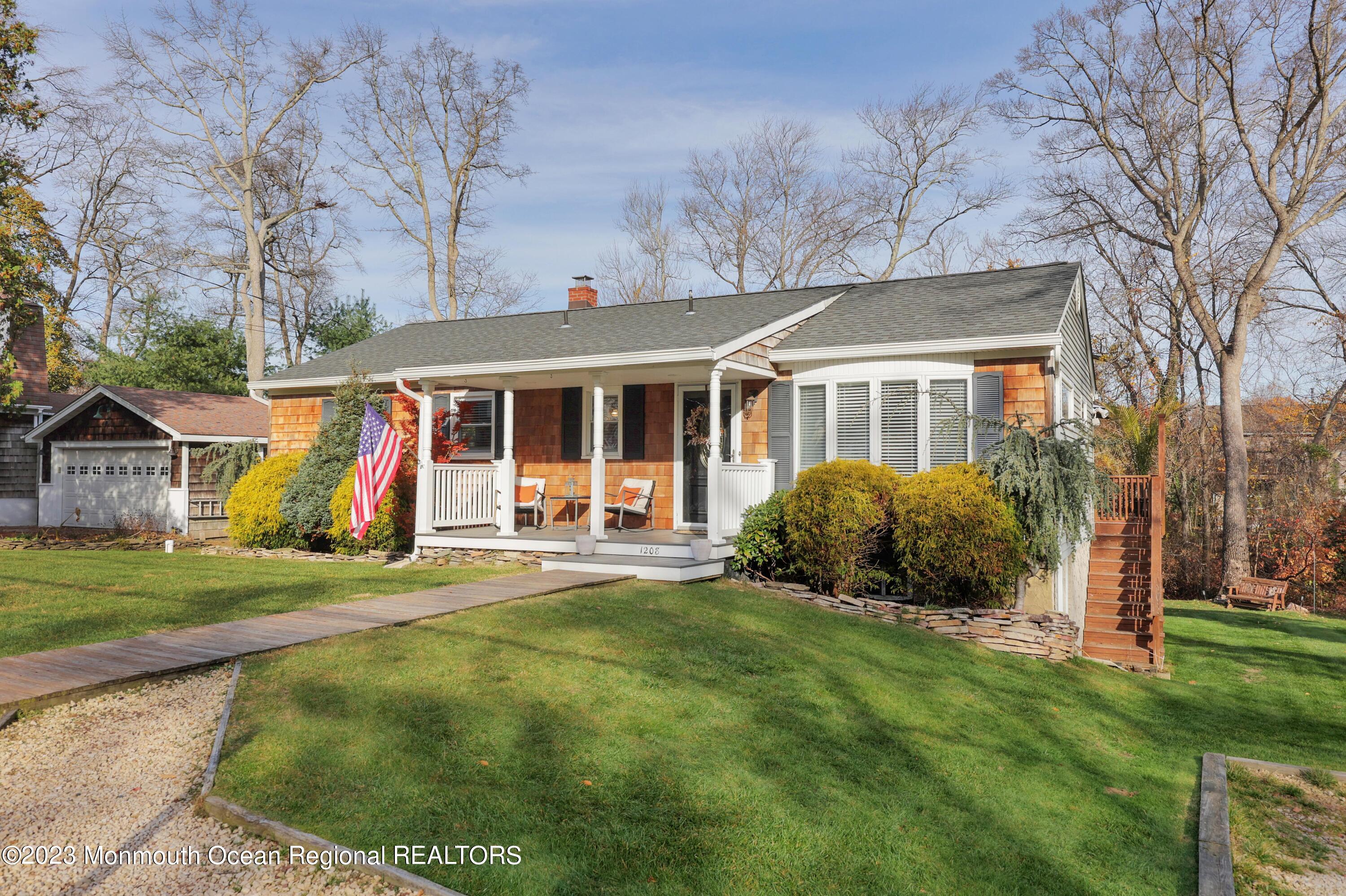 1208 Oak Road Manasquan, NJ 08736 - Photo 8 of 52 a view of a white house with a big yard and large trees