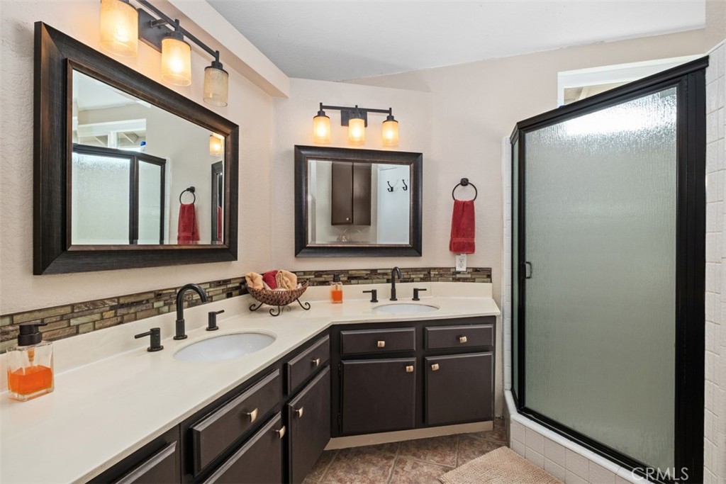 4 Firethorn Rancho Santa Margarita, CA 92688 - Photo 17 of 27 a bathroom with a double vanity sink and a mirror
