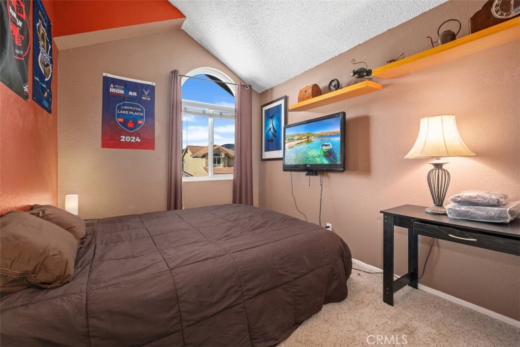 4 Firethorn Rancho Santa Margarita, CA 92688 - Photo 18 of 27 a bedroom with a bed and a lamp on dresser