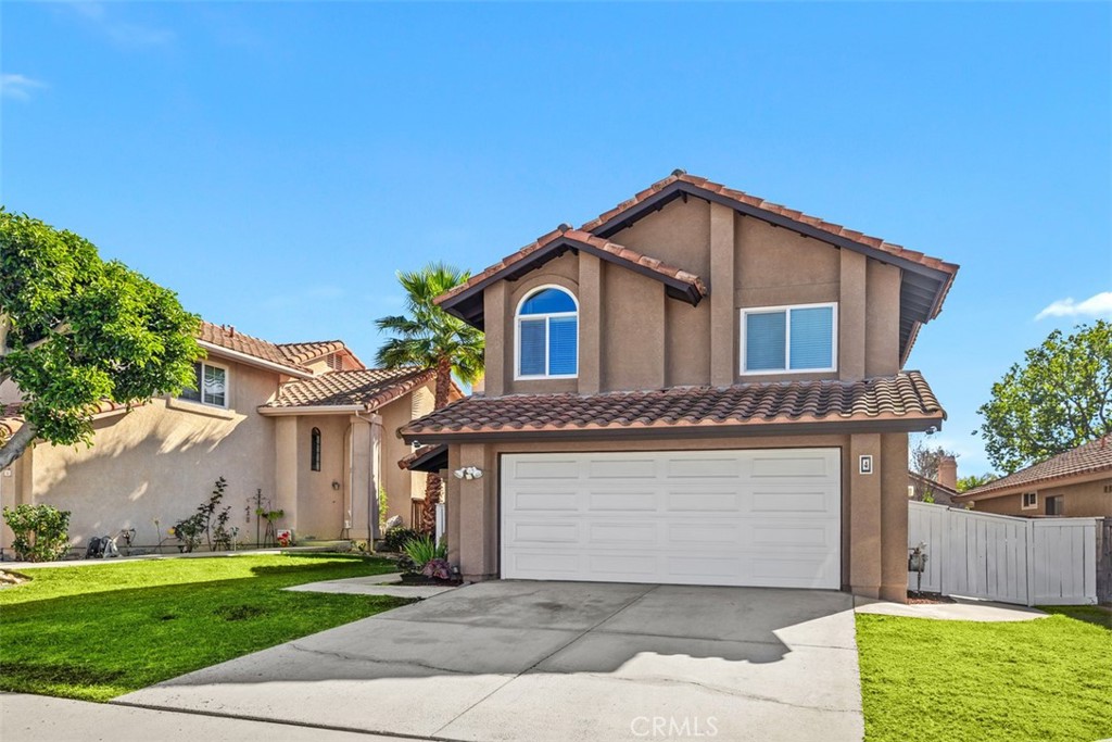 4 Firethorn Rancho Santa Margarita, CA 92688 - Photo 2 of 27 a front view of a house with a yard and garage
