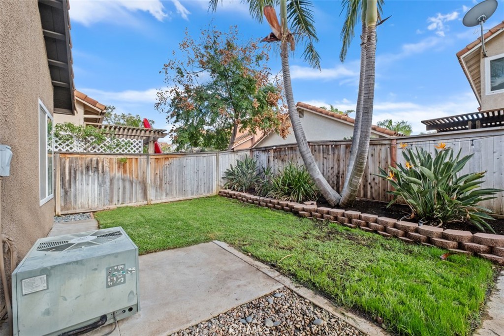 4 Firethorn Rancho Santa Margarita, CA 92688 - Photo 23 of 27 a view of a backyard with plants and wooden fence