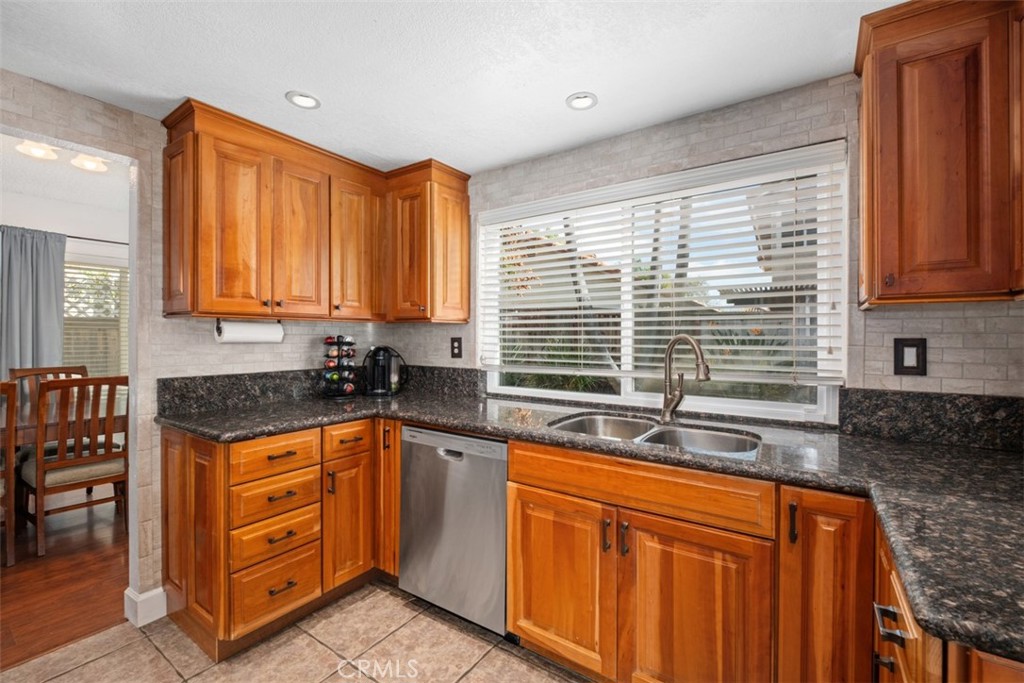 4 Firethorn Rancho Santa Margarita, CA 92688 - Photo 8 of 27 a kitchen with stainless steel appliances granite countertop a sink and a window