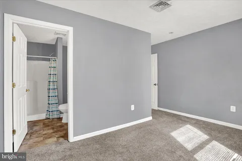an empty room with a bench and closet