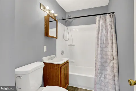 a bathroom with a shower toilet and sink