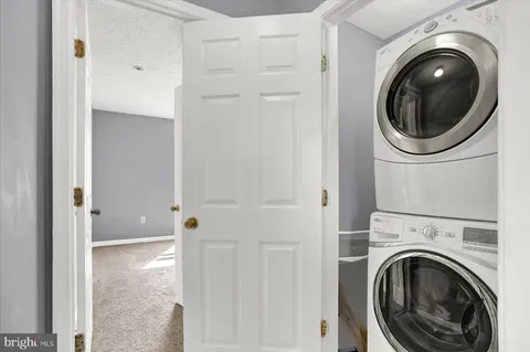 a view of a hallway with washer and dryer