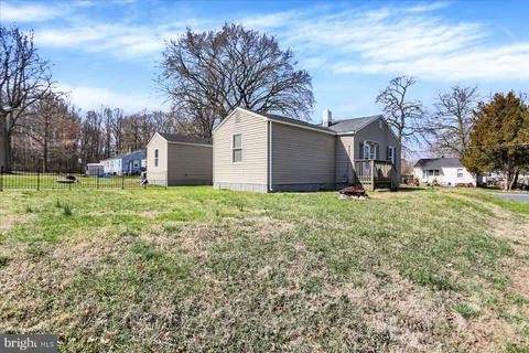 a view of a backyard with large trees