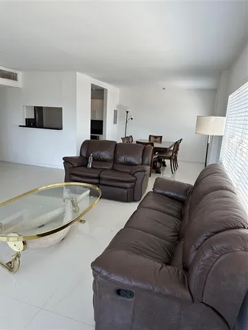 a kitchen with granite countertop a refrigerator and a sink
