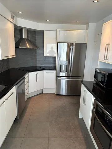 a kitchen with granite countertop a sink and a stove
