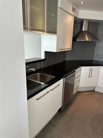 a view of a workspace with furniture and window