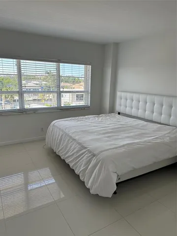 a view of a workspace with furniture and a bookshelf