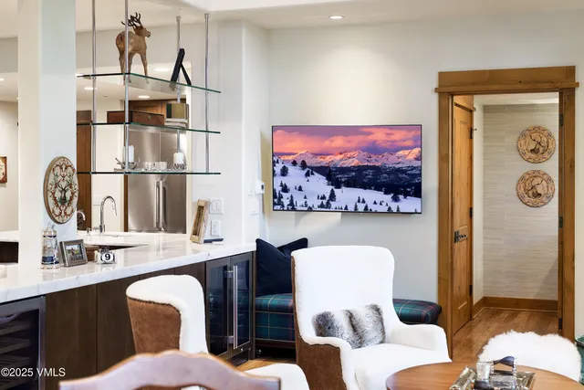 a kitchen with a table chairs sink and cabinets