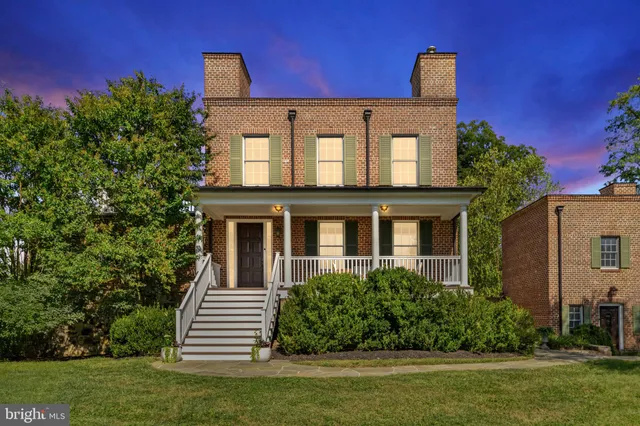 a kitchen with white cabinets sink and stainless steel appliances