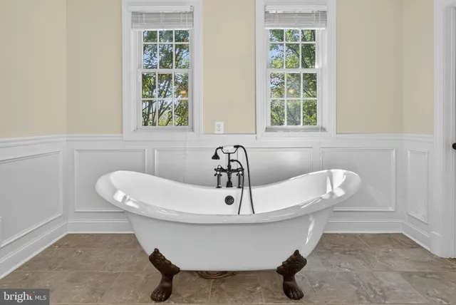 an aerial view of a house with a yard and mountain view