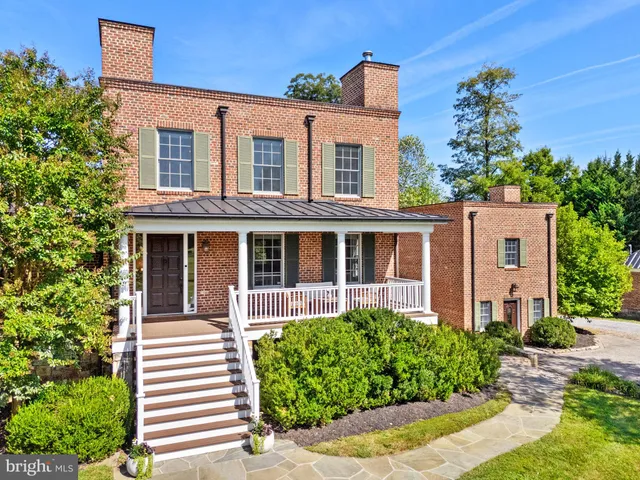 an aerial view of a house with a yard and garden