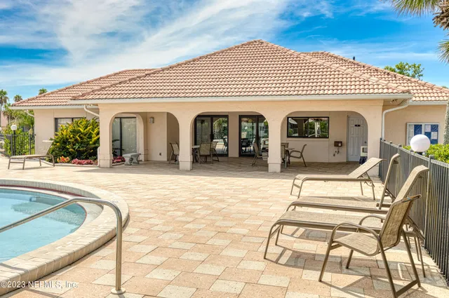 an aerial view of residential houses with outdoor space and swimming pool