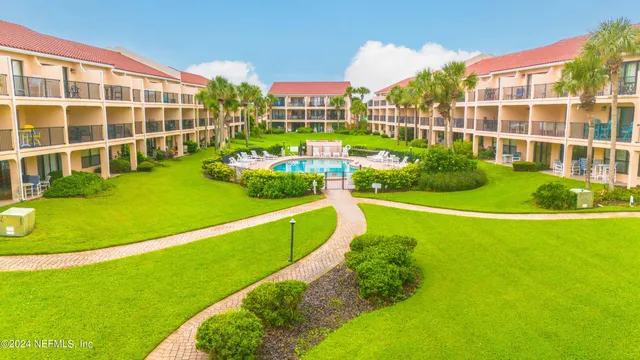 a view of a swimming pool with a yard and plants