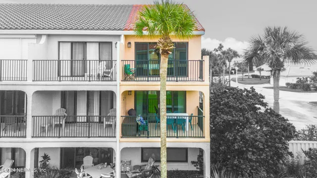 an aerial view of a house with a garden and lake view