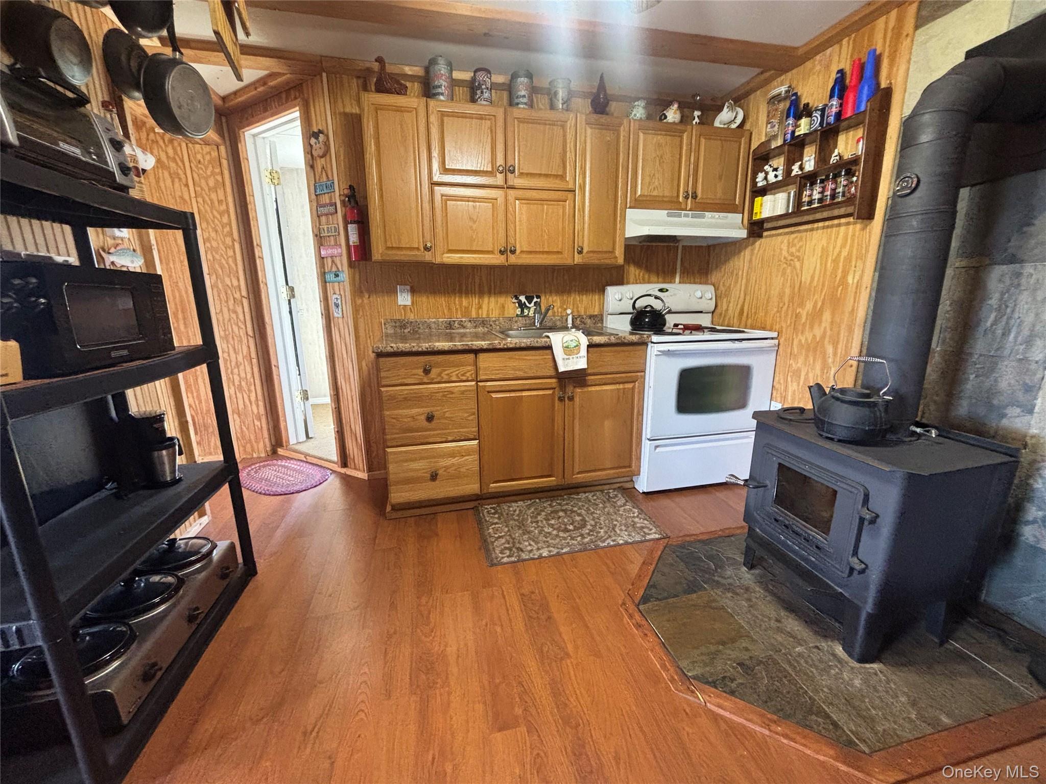 48 Mullen Road Parksville, NY 12768 - Photo 17 of 35 a kitchen with stainless steel appliances granite countertop a stove a sink and a refrigerator
