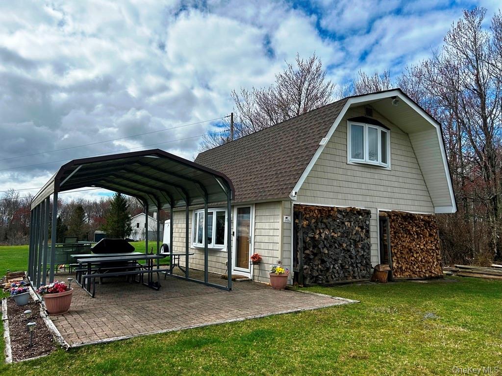 48 Mullen Road Parksville, NY 12768 - Photo 34 of 35 a backyard of a house with table and chairs
