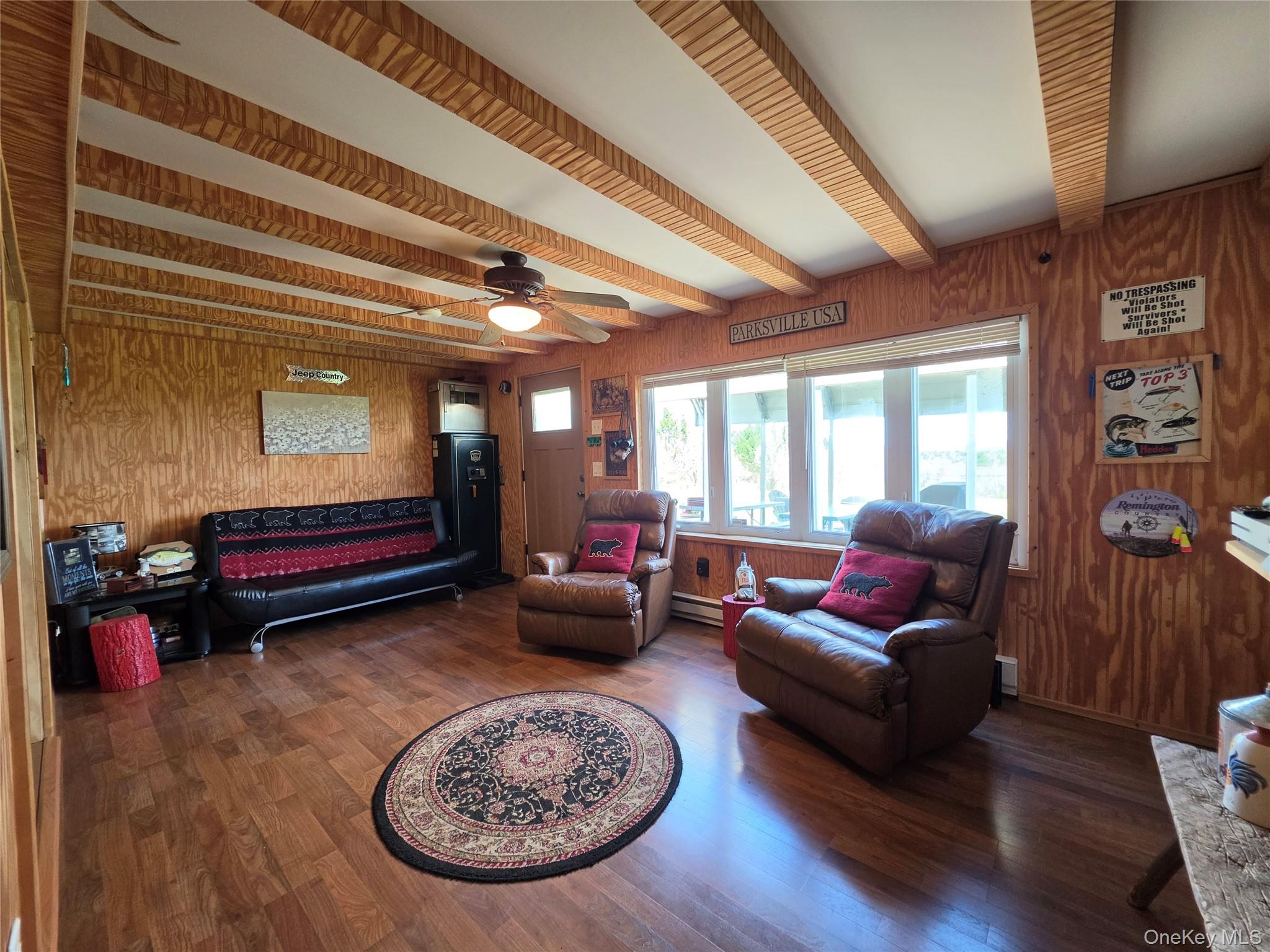 48 Mullen Road Parksville, NY 12768 - Photo 8 of 35 a living room with furniture a rug and a chandelier