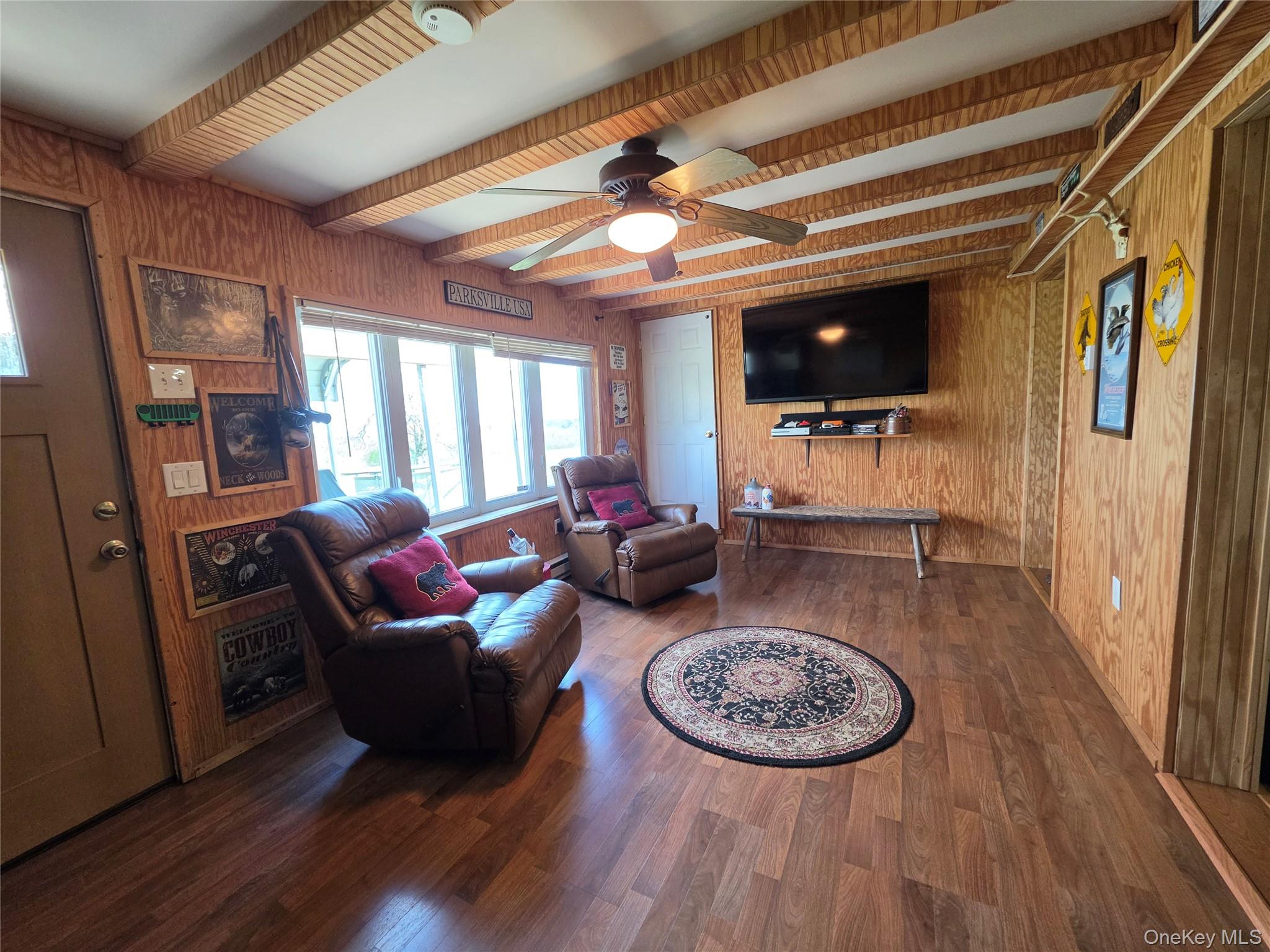 48 Mullen Road Parksville, NY 12768 - Photo 9 of 35 a living room with furniture a flat screen tv and a fireplace
