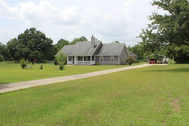 7164 Goodall Mill Road Macon, GA 31216 - Photo 2 of 12 a view of a house with a big yard and large trees