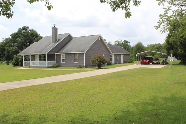 7164 Goodall Mill Road Macon, GA 31216 - Photo 12 of 12 a front view of a house with yard and green space