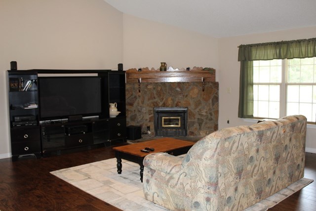7164 Goodall Mill Road Macon, GA 31216 - Photo 6 of 12 a living room with furniture a flat screen tv and a fireplace