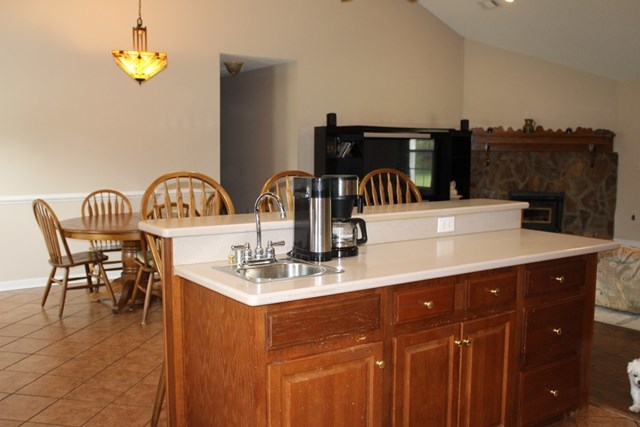 7164 Goodall Mill Road Macon, GA 31216 - Photo 8 of 12 a kitchen with kitchen island granite countertop a sink a counter space and cabinets