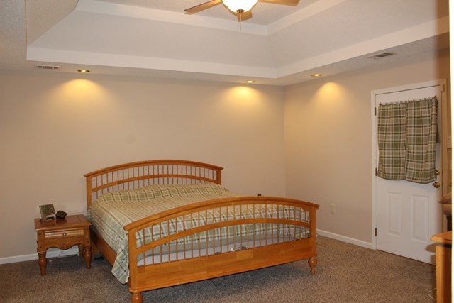 7164 Goodall Mill Road Macon, GA 31216 - Photo 9 of 12 a bedroom with a bed and a chandelier