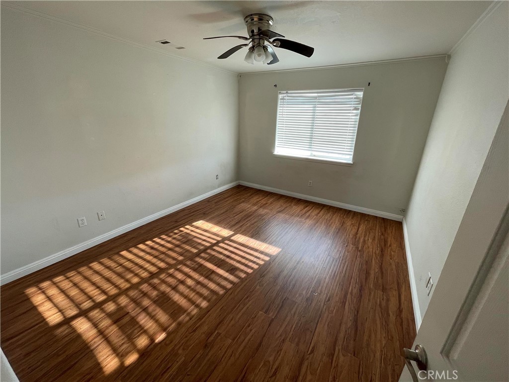 8354 White Road Phelan, CA 92371 - Photo 11 of 43 a view of an empty room with wooden floor and a window