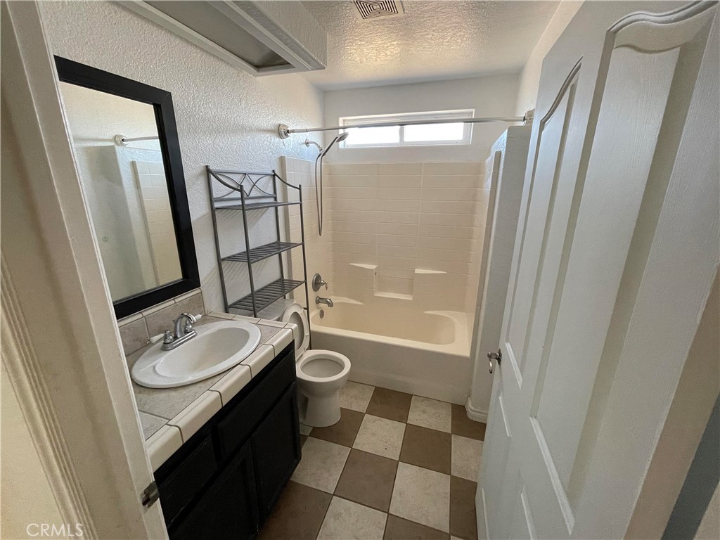 8354 White Road Phelan, CA 92371 - Photo 12 of 43 a bathroom with a sink a toilet a mirror and shower