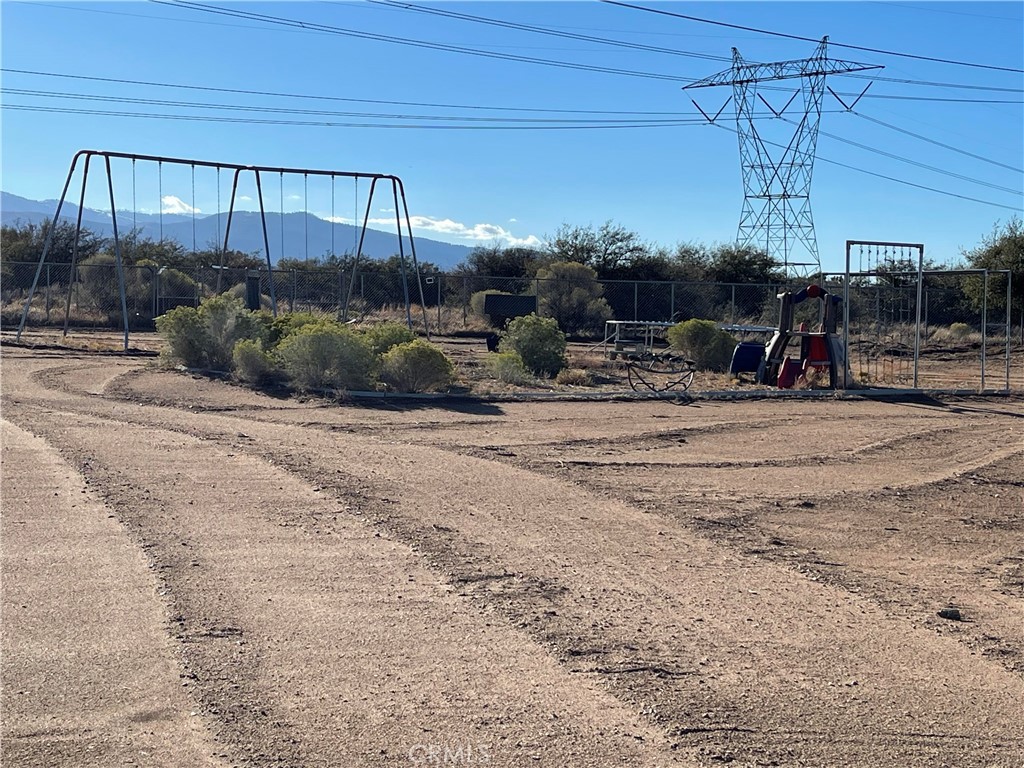 8354 White Road Phelan, CA 92371 - Photo 17 of 43 a view of a house with large trees and wooden fence