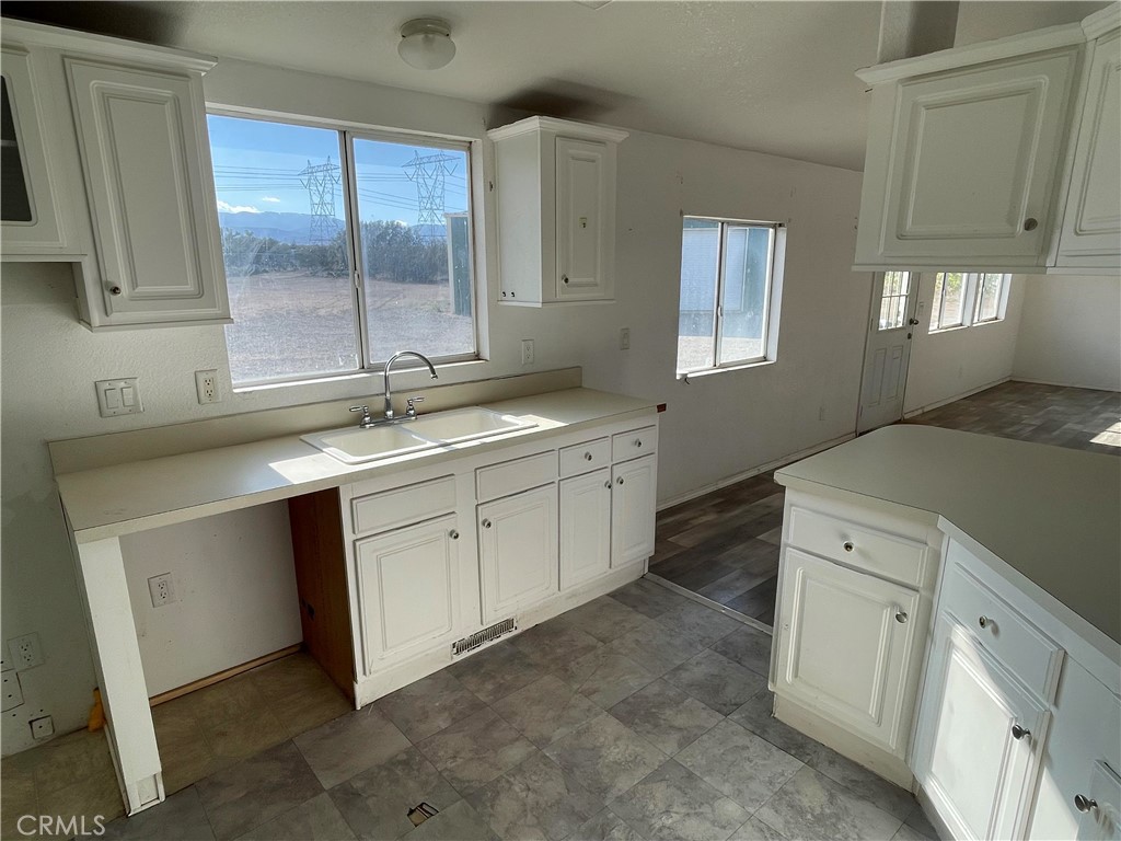 8354 White Road Phelan, CA 92371 - Photo 25 of 43 a spacious bathroom with a sink double vanity granite and a mirror