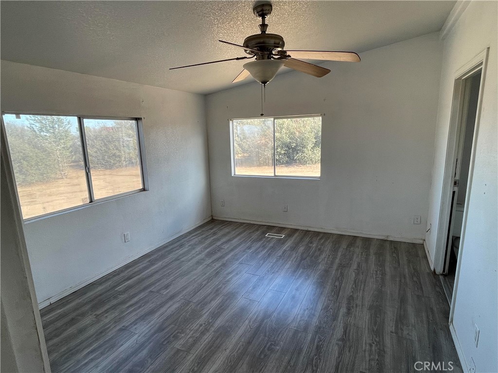 8354 White Road Phelan, CA 92371 - Photo 29 of 43 a view of an empty room with wooden floor and a window