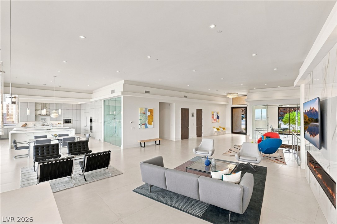 677 Overlook Rim Drive Henderson, NV 89012 - Photo 9 of 97 High ceilings and clean architectural lines define this expansive, modern open-concept living area.
